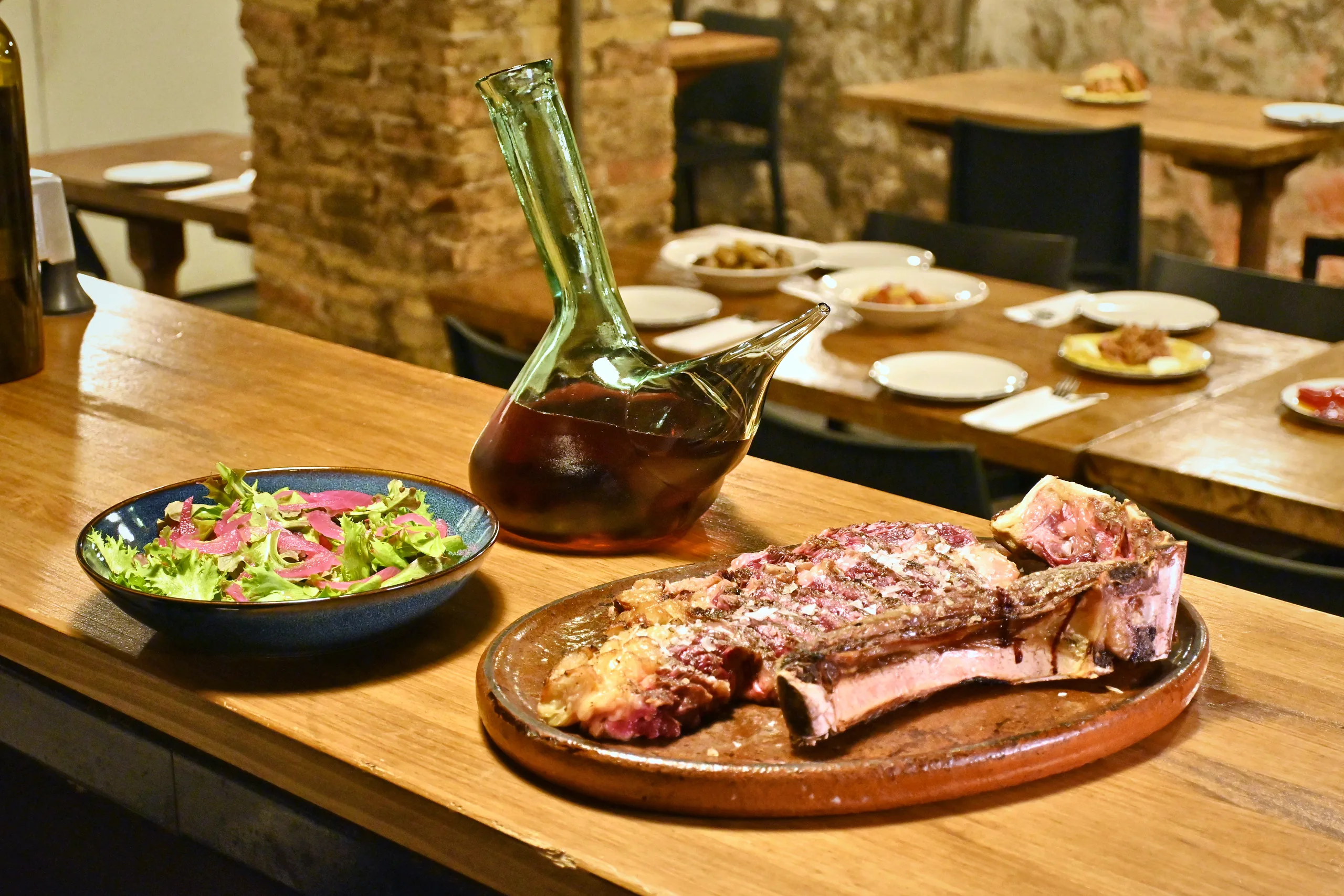 La barra de Soroeta con una txuleta y un porrón de sidra
